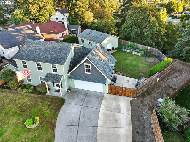 an aerial view of a house with a yard