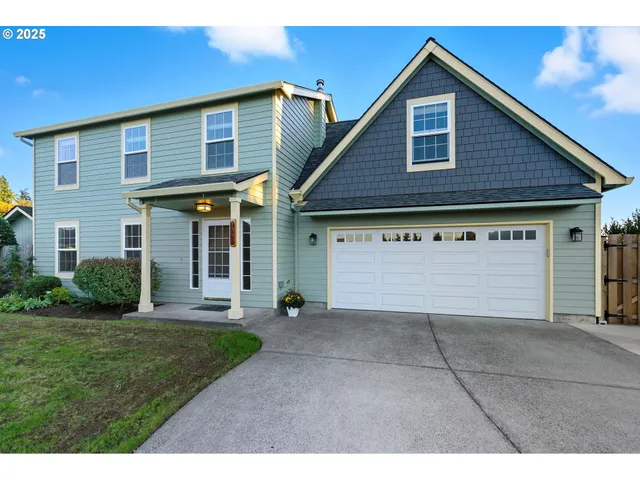 a view of a house with a yard and garage