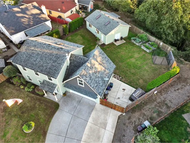 an aerial view of a backyard with table and chairs