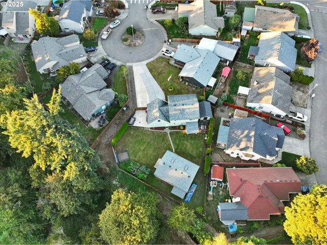 an aerial view of a houses with yard