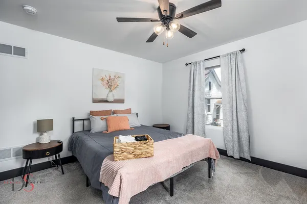 a bedroom with a bed and a chandelier