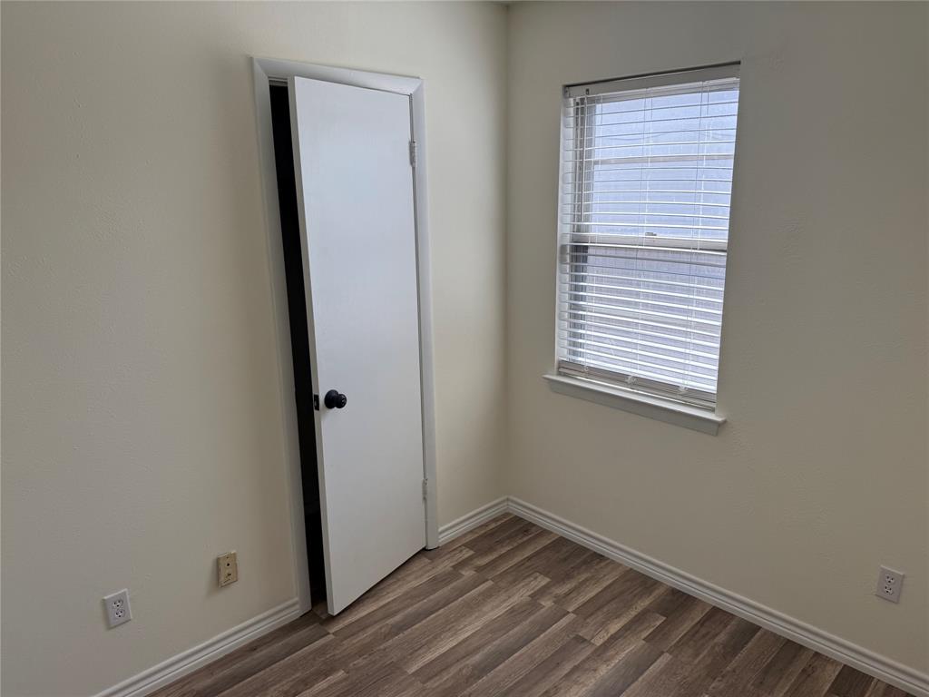 609 Crane Drive Euless, TX 76039 - Photo 11 of 15 a view of a small space with wooden floor and a window