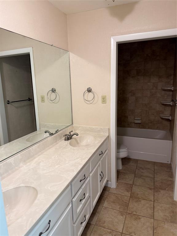 609 Crane Drive Euless, TX 76039 - Photo 8 of 15 a bathroom with a granite countertop sink a toilet and bathtub