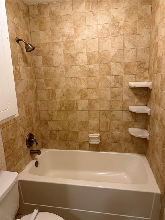 609 Crane Drive Euless, TX 76039 - Photo 9 of 15 a bathroom with a bathtub and a toilet