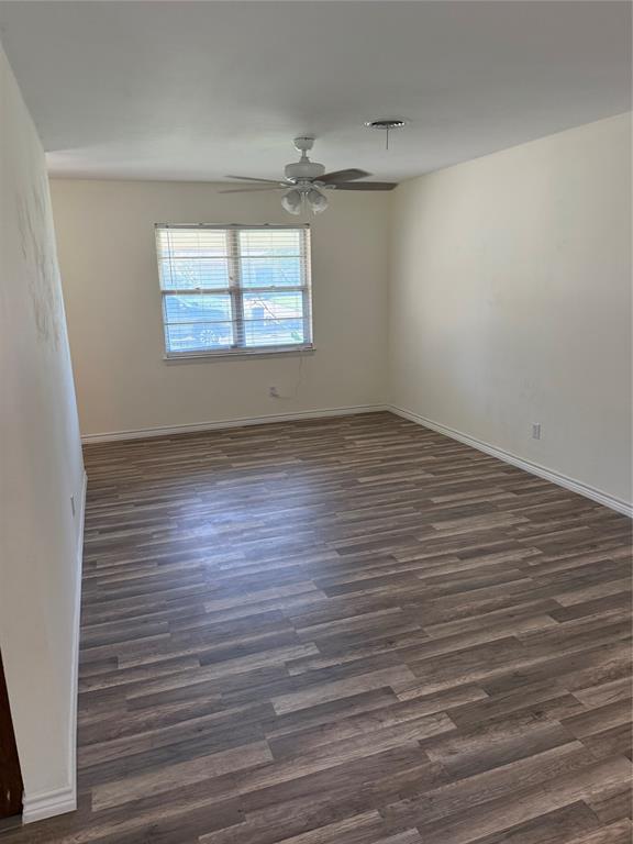 609 Crane Drive Euless, TX 76039 - Photo 10 of 15 wooden floor in an empty room with a window