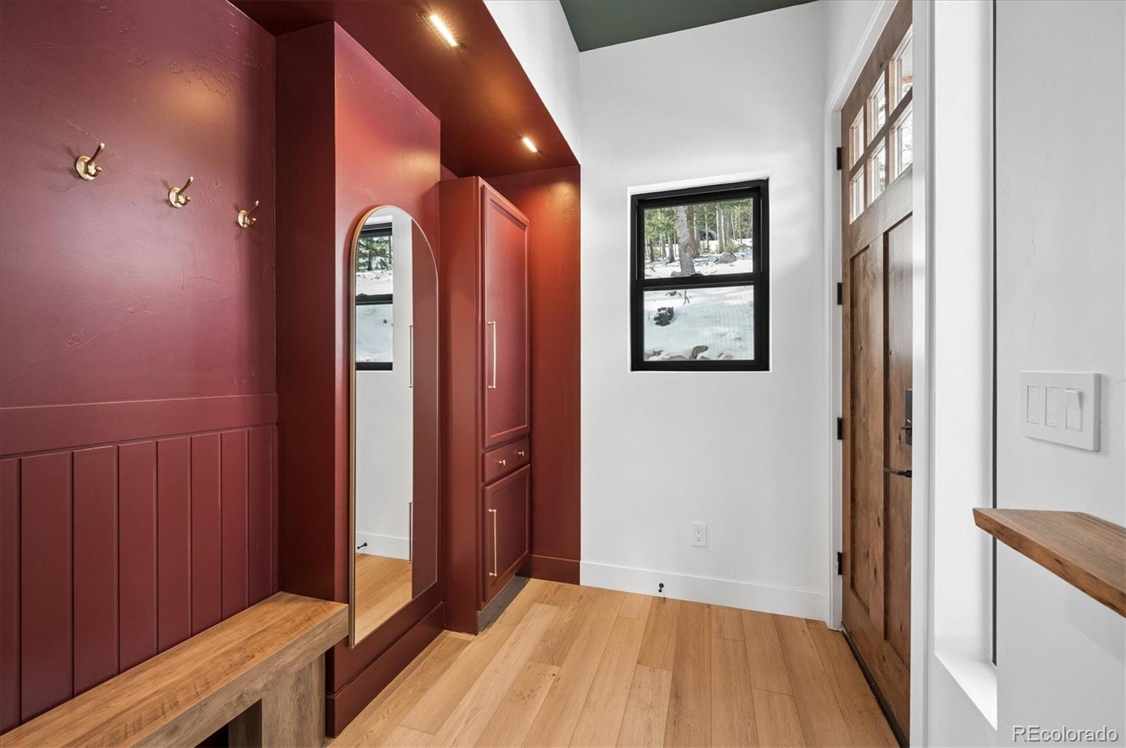 1633 Sinton Road Evergreen, CO 80439 - Photo 21 of 50 a view of a hallway with wooden floor and entryway