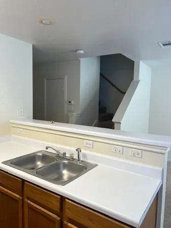 a sink sitting next to a white cabinet
