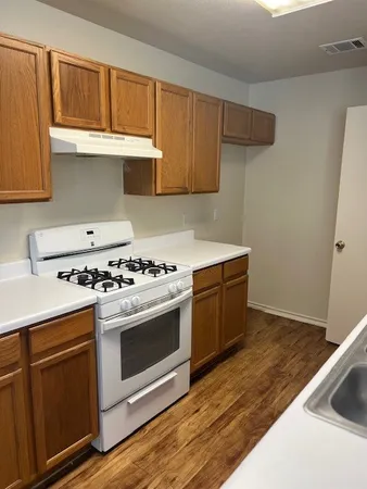 a kitchen with granite countertop a stove and a sink
