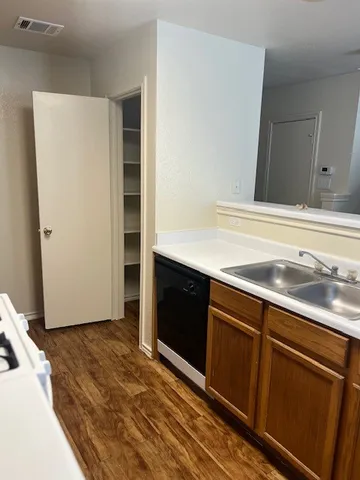 a view of a kitchen with wooden floor