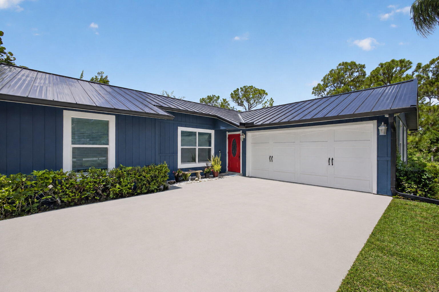 12558 165th Road North Jupiter, FL 33478 - Photo 17 of 67 a front view of a house with a yard and garage