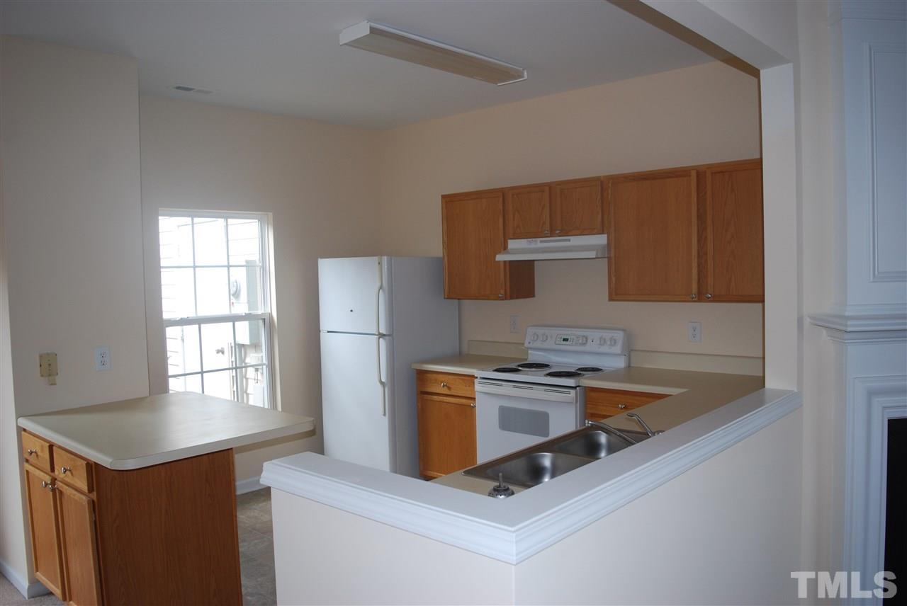 5326 Glen Canyon Road Raleigh, NC 27616 - Photo 2 of 6 a kitchen that has a sink and a stove in it
