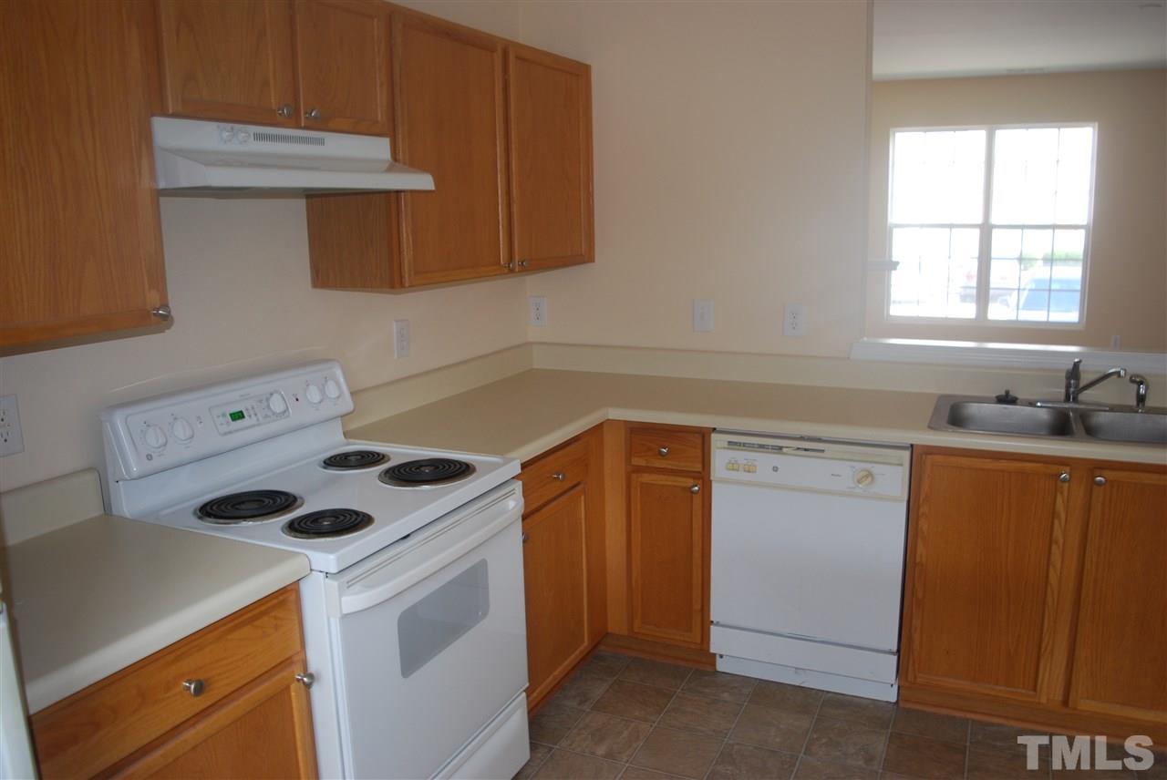 5326 Glen Canyon Road Raleigh, NC 27616 - Photo 5 of 6 a kitchen with a sink cabinets and a stove top oven