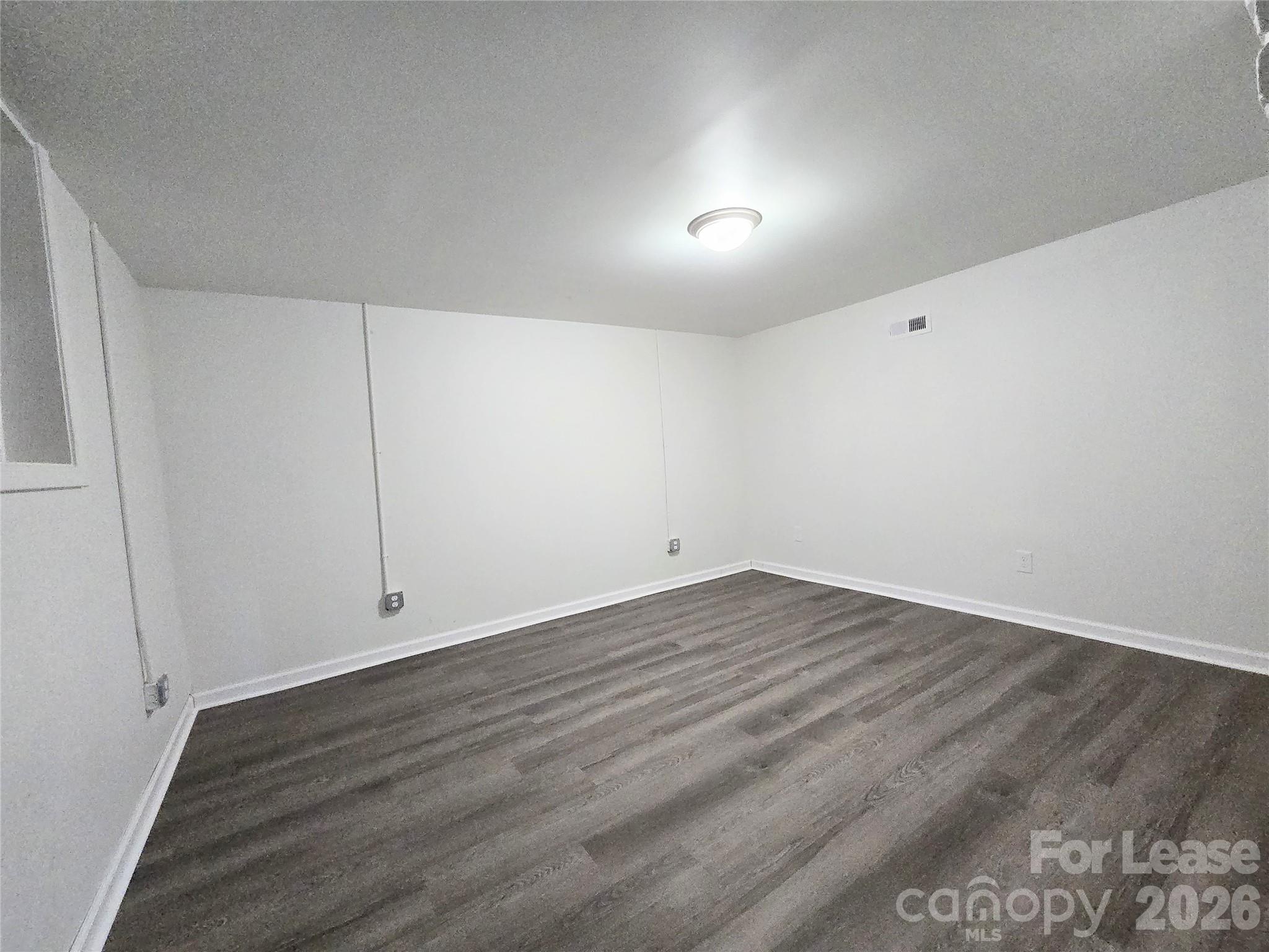 101 South Webb Street Gastonia, NC 28052 - Photo 13 of 40 a view of an empty room with wooden floor