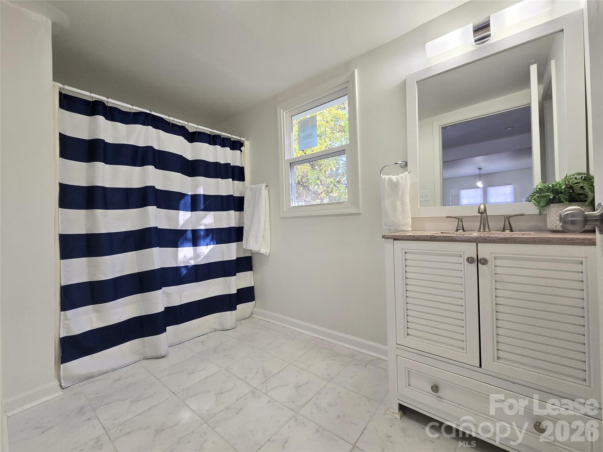 101 South Webb Street Gastonia, NC 28052 - Photo 16 of 40 a bedroom with a sink and a mirror