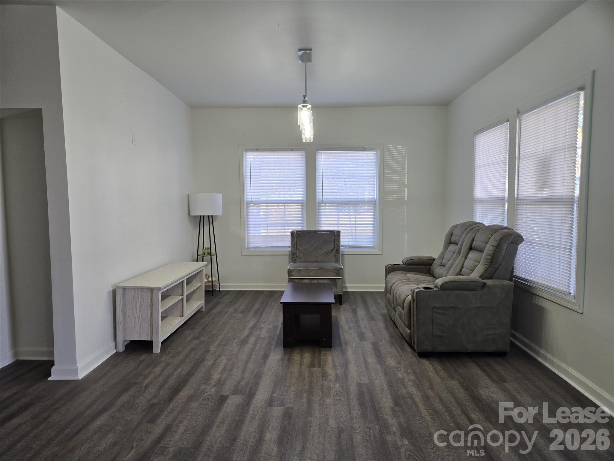 101 South Webb Street Gastonia, NC 28052 - Photo 17 of 40 a living room with furniture and a wooden floor