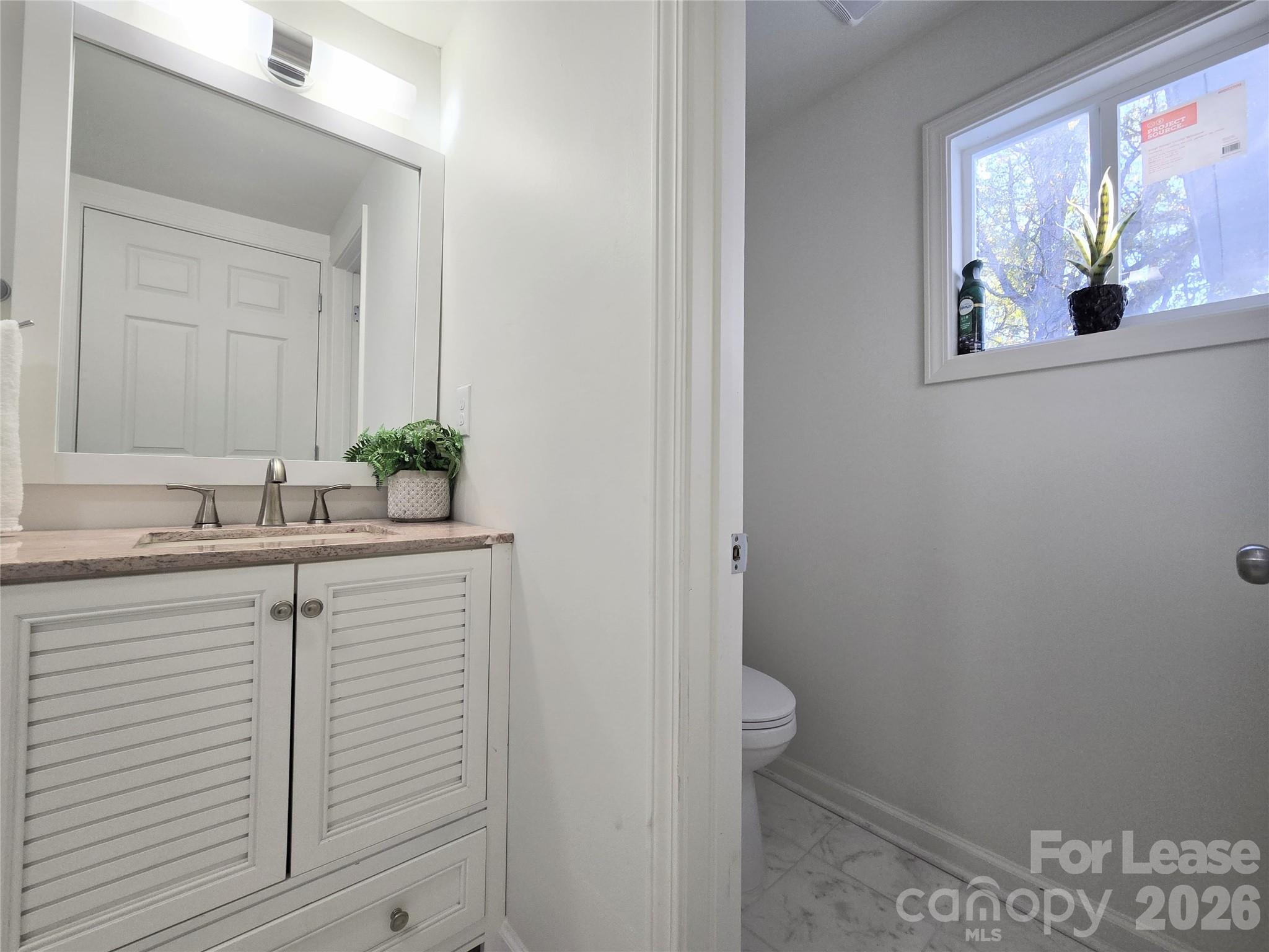 101 South Webb Street Gastonia, NC 28052 - Photo 19 of 40 a bathroom with a sink and a mirror
