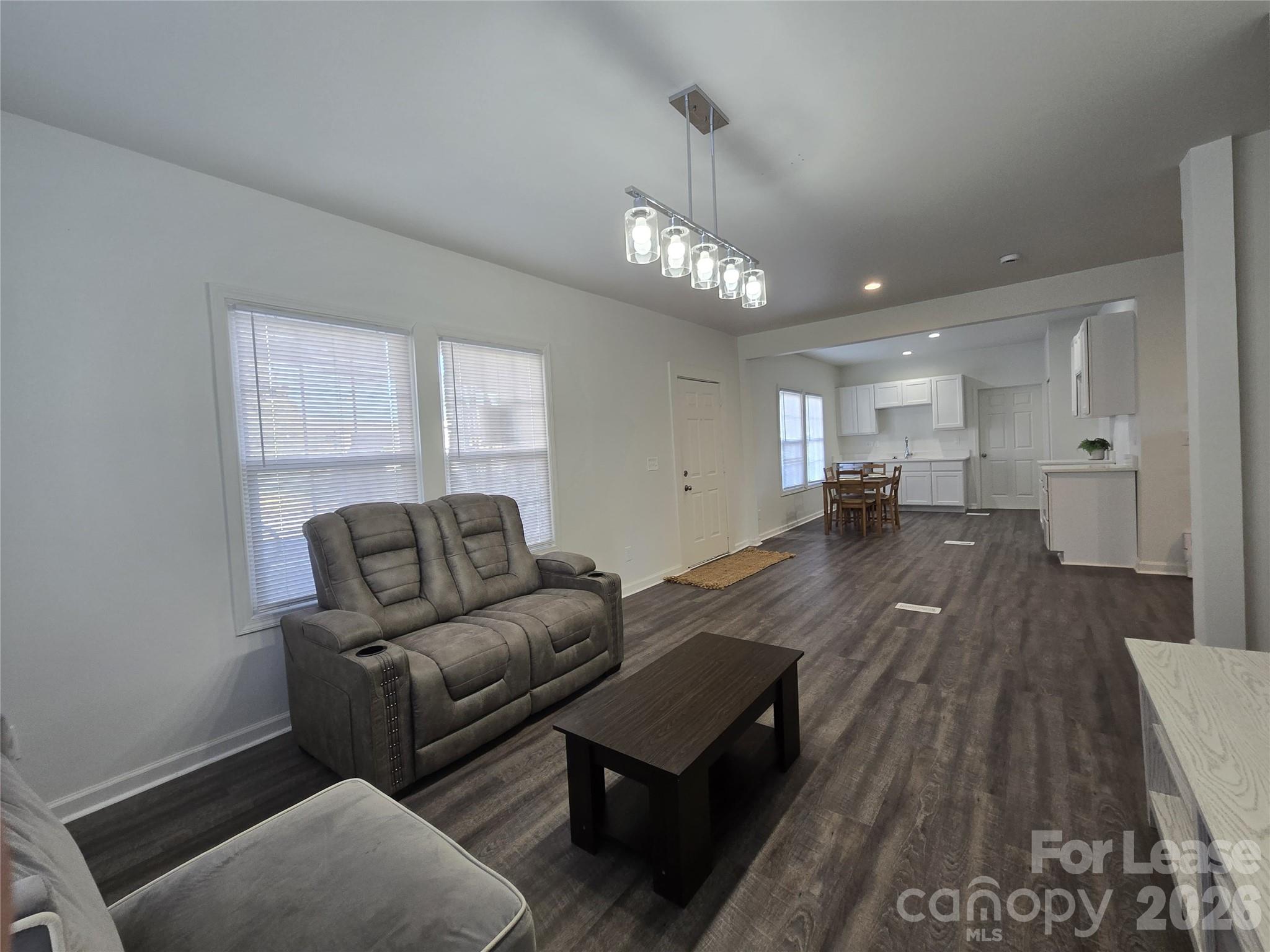 101 South Webb Street Gastonia, NC 28052 - Photo 23 of 40 a living room with furniture and a wooden floor