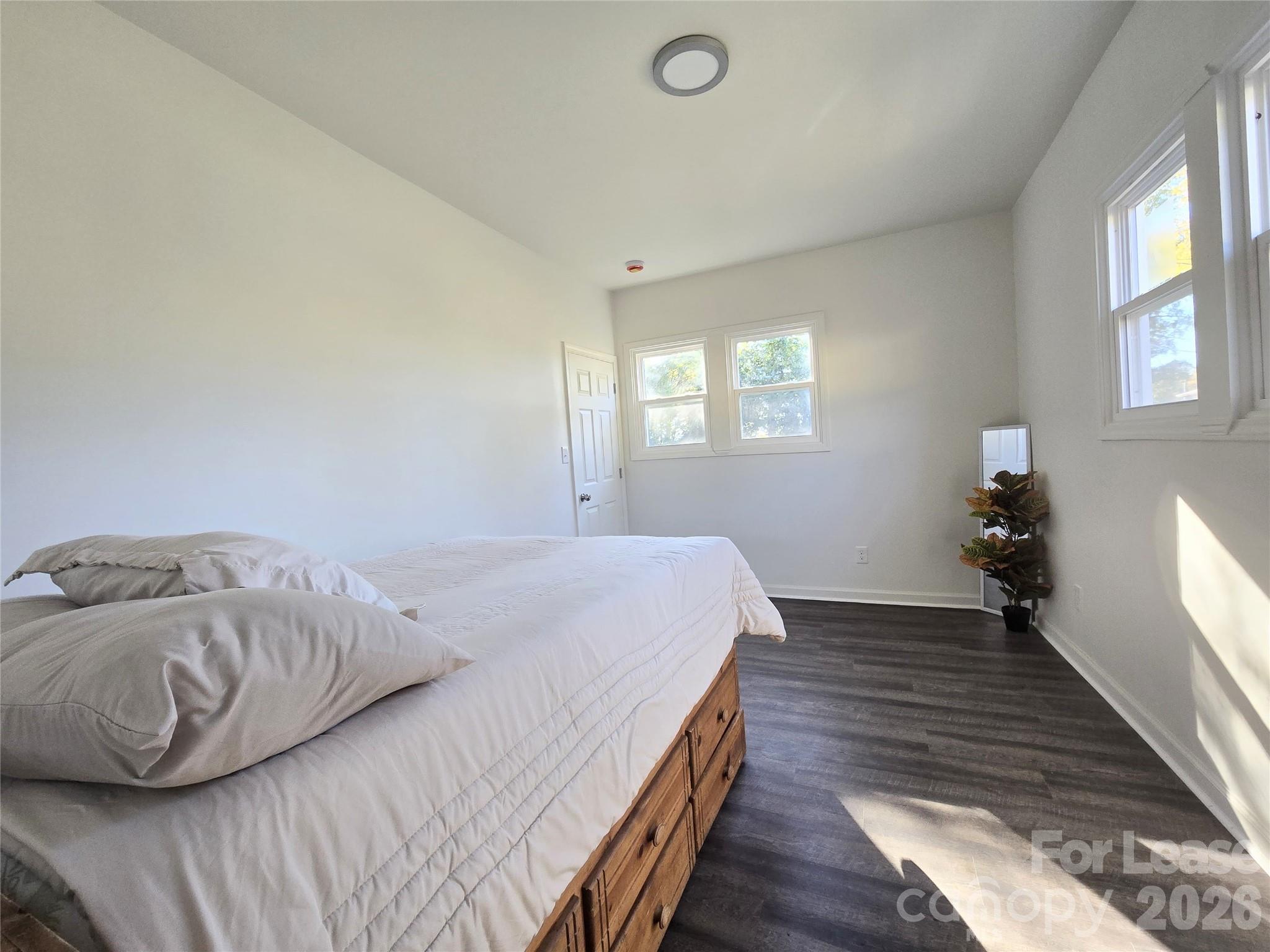 101 South Webb Street Gastonia, NC 28052 - Photo 24 of 40 a bedroom with a bed and wooden floor