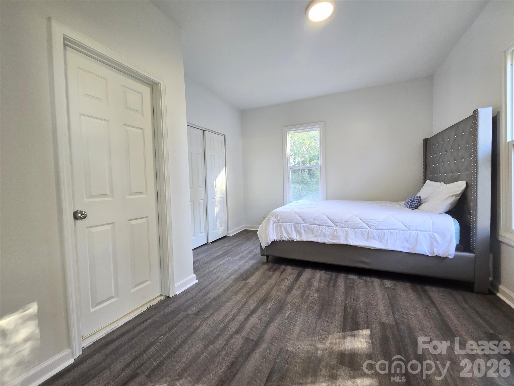 101 South Webb Street Gastonia, NC 28052 - Photo 35 of 40 a bedroom with a bed and wooden floor