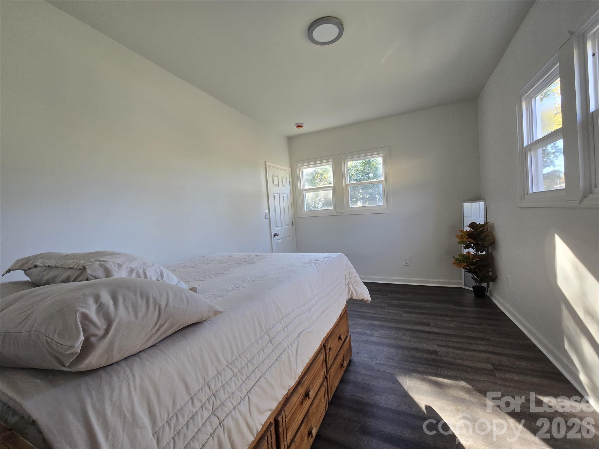 101 South Webb Street Gastonia, NC 28052 - Photo 36 of 40 a bed sitting in a bedroom next to a window