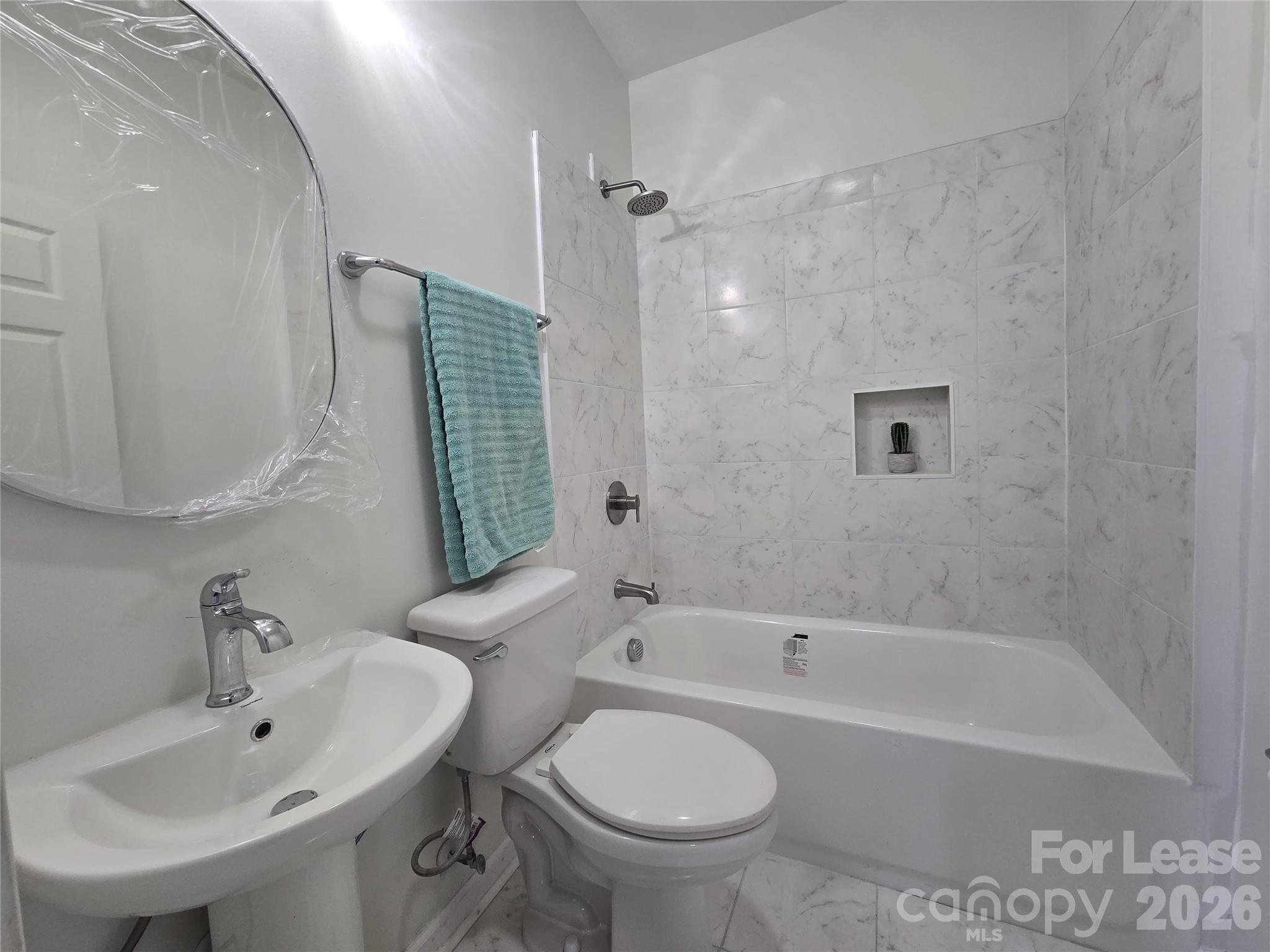 101 South Webb Street Gastonia, NC 28052 - Photo 7 of 40 a bathroom with a sink toilet and bathtub