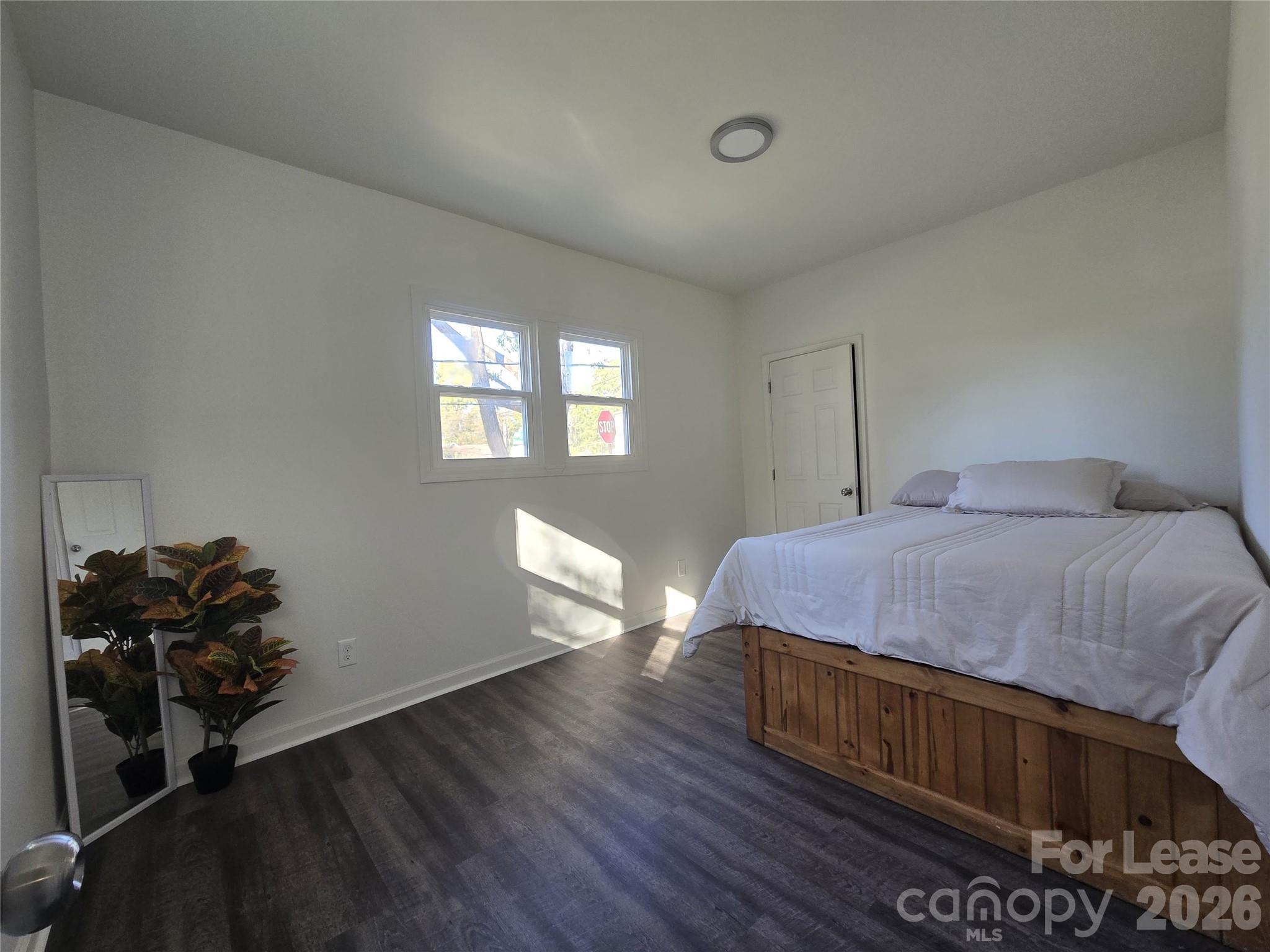 101 South Webb Street Gastonia, NC 28052 - Photo 9 of 40 a bedroom with a bed and wooden floor