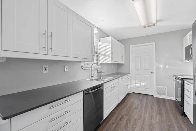 a kitchen with a refrigerator and a sink