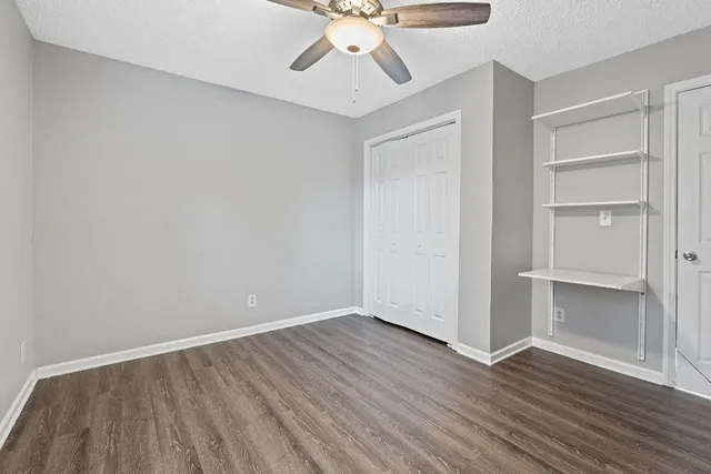a bathroom with a bathtub shower sink vanity and mirror