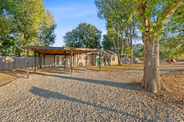 a view of a yard with wooden fence