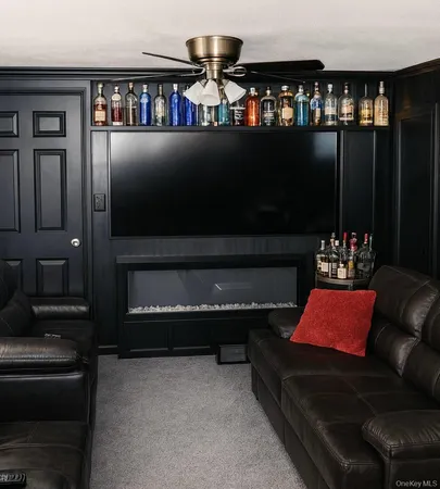 a living room with furniture a flat screen tv and lamp