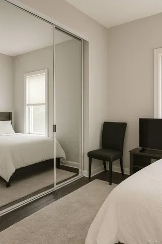 a bedroom with a bed and a tv on table