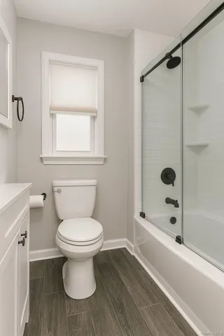 a bathroom with a toilet and a shower