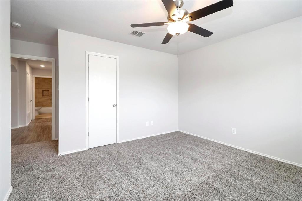 5528 Ridge View Drive Watauga, TX 76137 - Photo 12 of 16 Bedroom with carpet floors, ceiling fan, and a closet- off Entry way - Hall bathroom off hall.