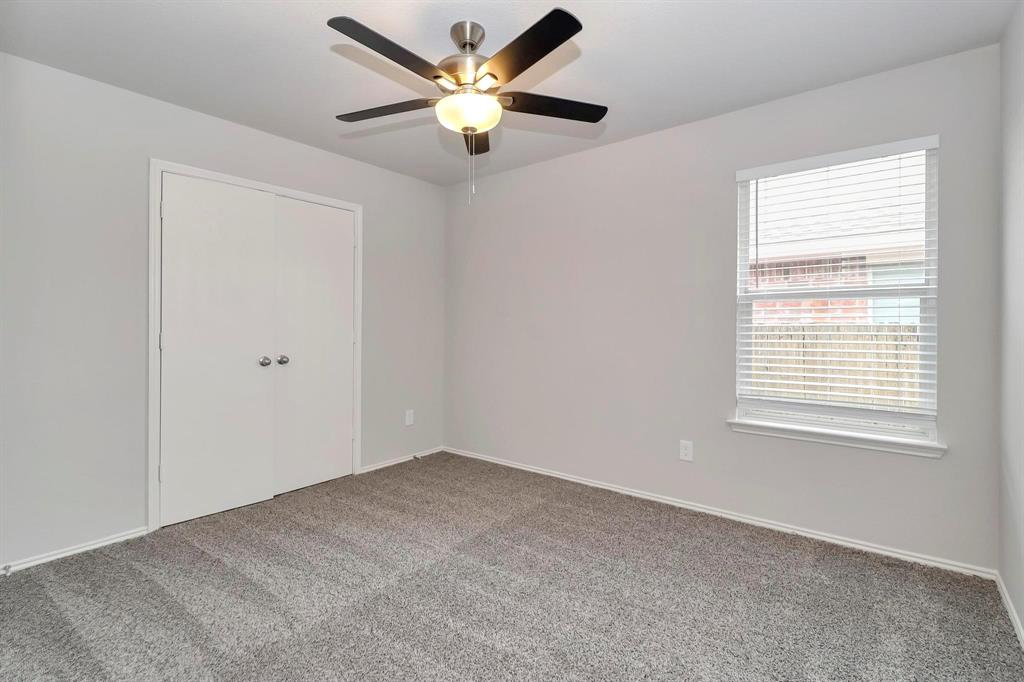 5528 Ridge View Drive Watauga, TX 76137 - Photo 14 of 16 bedroom featuring carpet, a closet, and a ceiling fan...