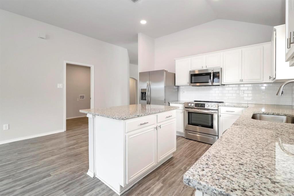 5528 Ridge View Drive Watauga, TX 76137 - Photo 7 of 16 Kitchen with white cabinetry, stainless steel appliances, backsplash, light stone counters, and recessed lighting