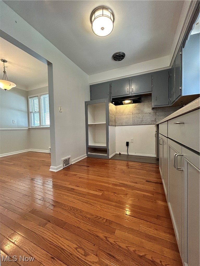 20739 Donnybrook Road Maple Heights, OH 44137 - Photo 4 of 22 Kitchen featuring gray cabinets, dark wood finished floors, and backsplash
