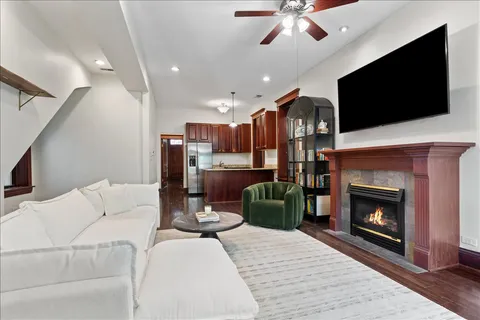 a living room with furniture a flat screen tv and a fireplace