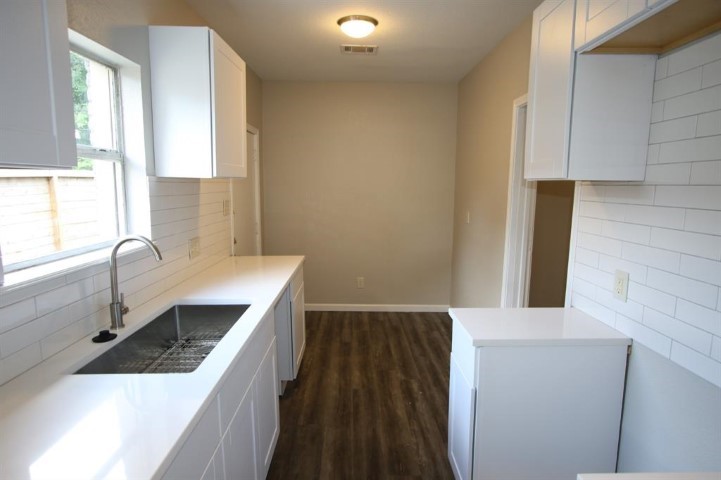 2612 Isabella Street Houston, TX 77004 - Photo 18 of 40 a kitchen with a sink and a stove top oven