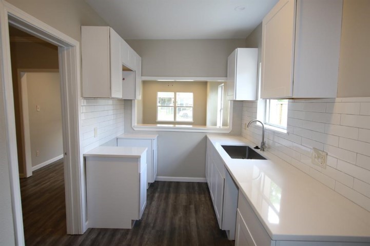 2612 Isabella Street Houston, TX 77004 - Photo 19 of 40 a kitchen with granite countertop white cabinets and sink