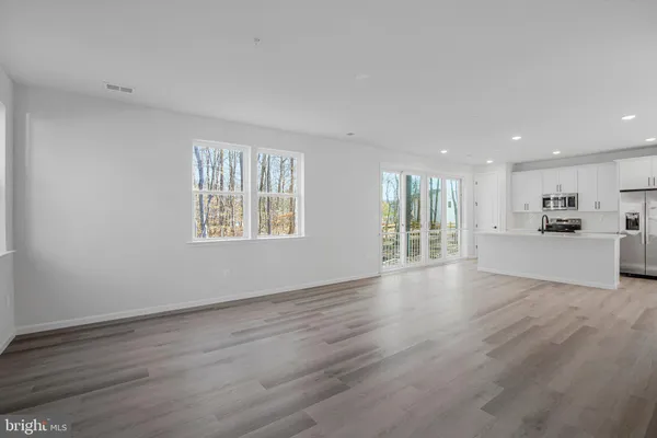 a view of a kitchen with wooden floor and a kitchen