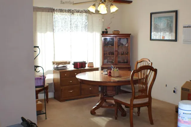 a view of a dining room with furniture and chandelier