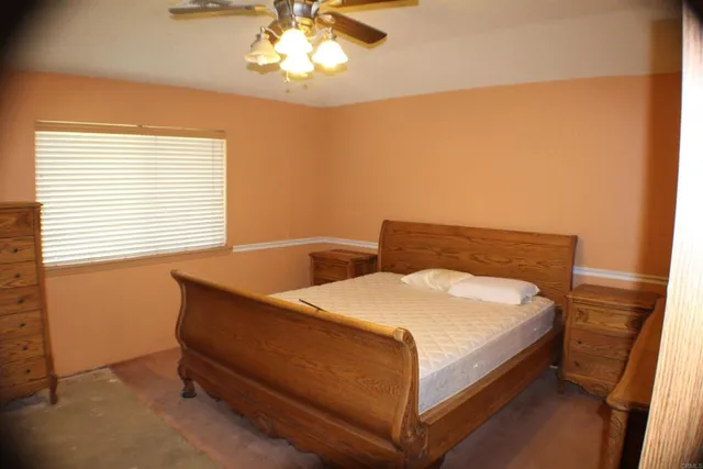 a bed sitting in a bedroom next to a window