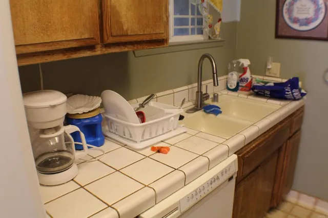 a kitchen with a sink and a stove top oven