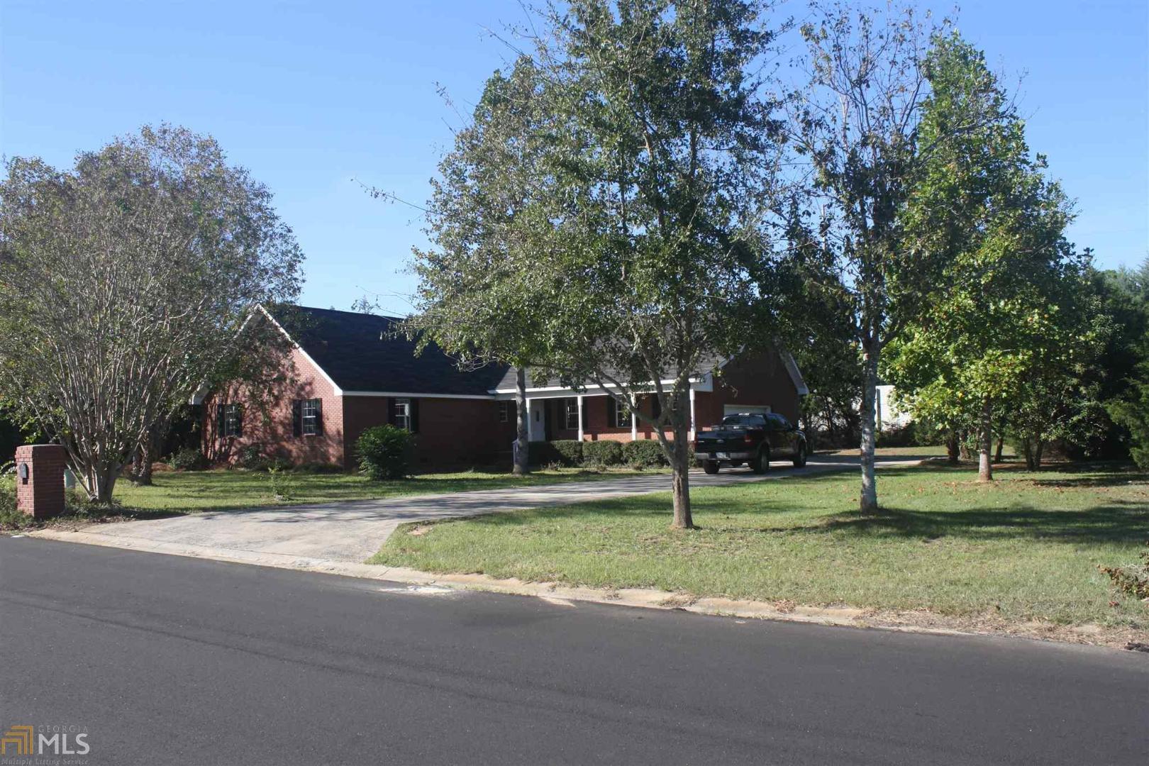 a backyard of a house with entertaining space and trampoline