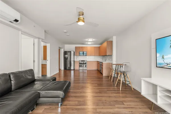 a living room with furniture and a wooden floor