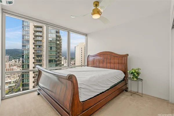 a bed sitting in a bedroom next to a window
