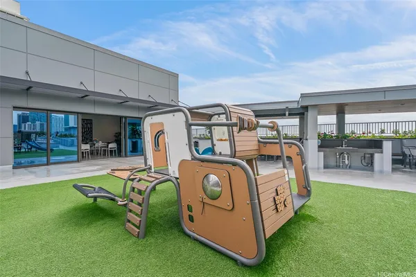 a view of a backyard with furniture and a backyard