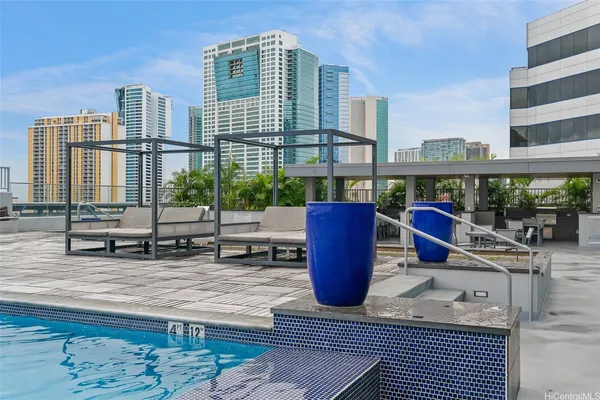 a view of roof deck with dining table and chairs