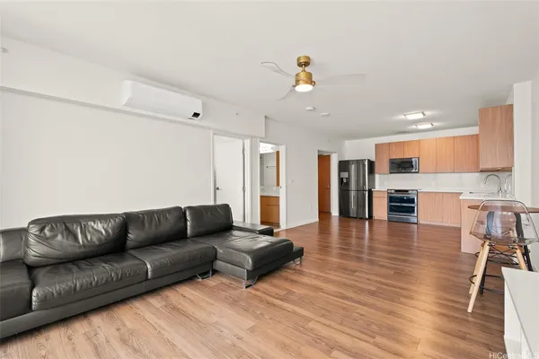 a living room with furniture and kitchen view