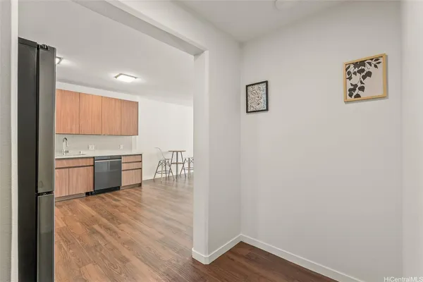 a kitchen with a refrigerator and a stove top oven
